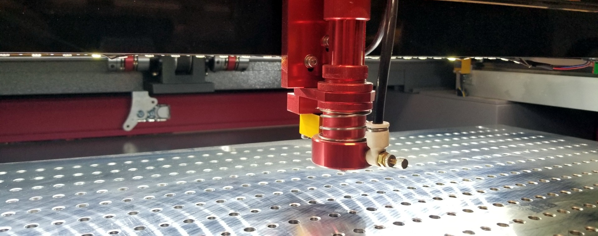Laser head about to drill into some metal.