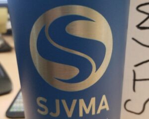 Laser etched blue stainless steel tumbler featuring San Joaquin Valley Manufacturing Alliance logo