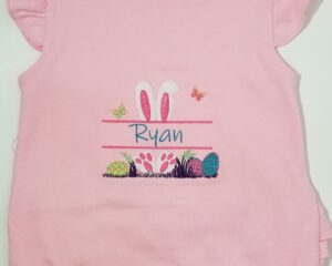 Custom embroidered pink ruffled baby shirt with Easter bunny ears and name Ryan