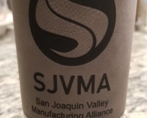 Custom laser etched grey cup sleeve featuring San Joaquin Valley Manufacturing Alliance branding