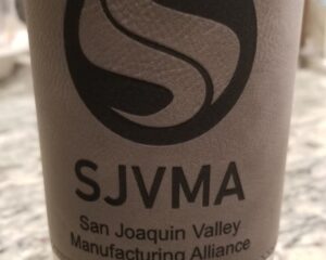 Custom laser etched grey cup sleeve featuring San Joaquin Valley Manufacturing Alliance branding